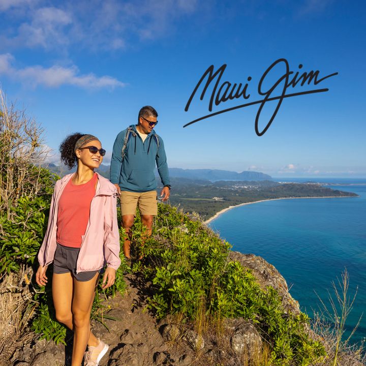 Couple wearing Maui Jim Sunglasses hiking lakeside